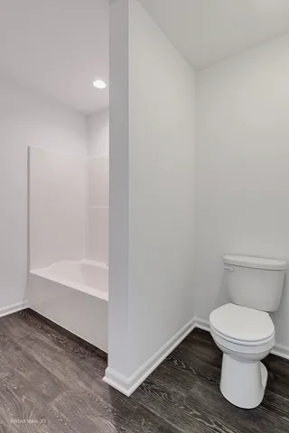 an empty room with closet and windows