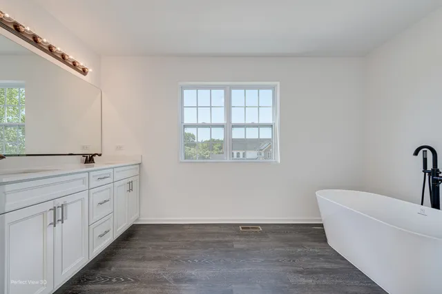 a white bath tub sitting next to a shower