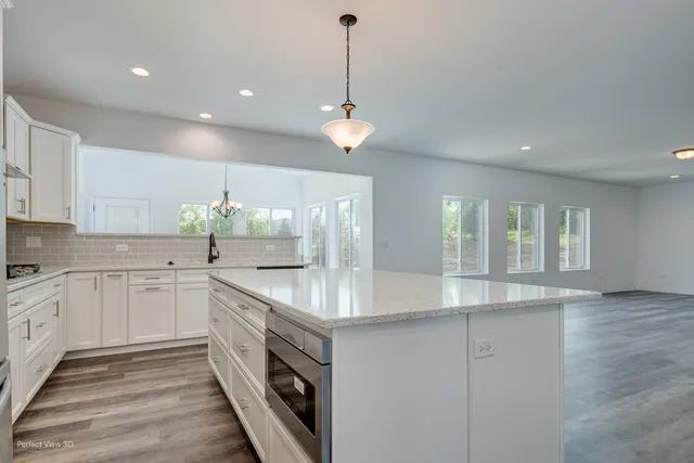 a kitchen with granite countertop a stove and a sink