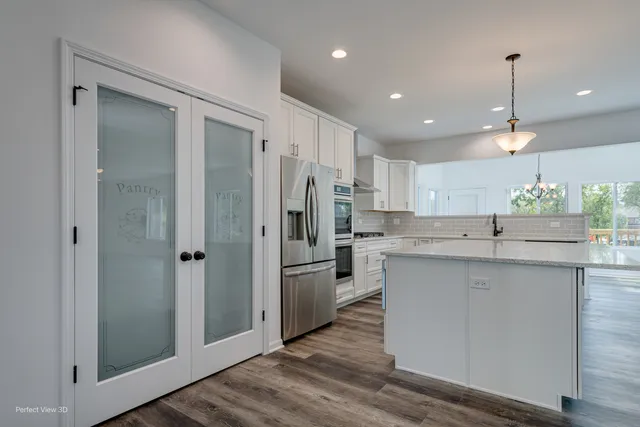 a kitchen with stainless steel appliances a refrigerator sink and stove