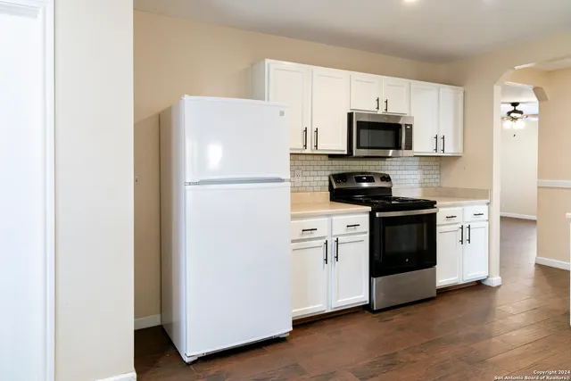 a white refrigerator freezer sitting in a kitchen