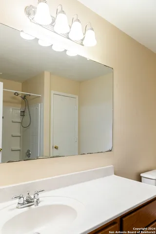 a bathroom with a sink and a mirror