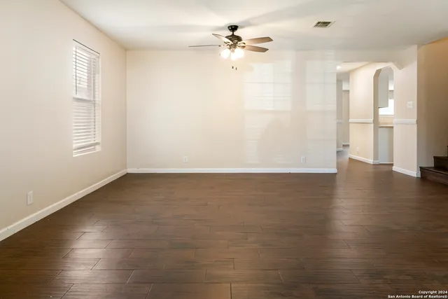 wooden floor in an empty room with a window