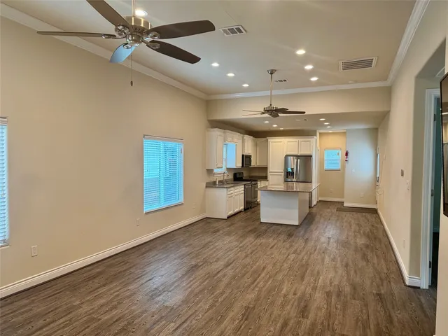 a view of a kitchen with furniture and wooden floor