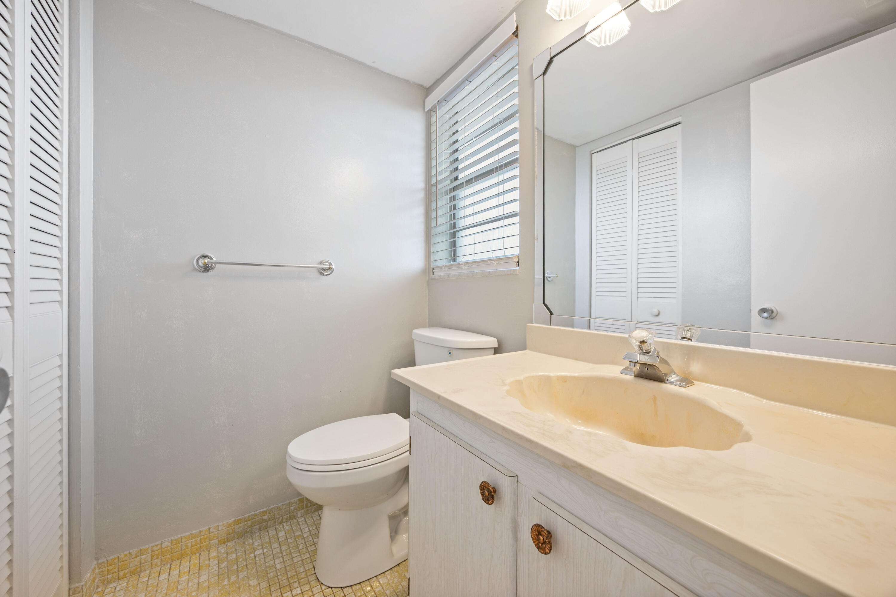 230 Northeast 26th Avenue, Unit 206 Boynton Beach, FL 33435 - Photo 13 of 25 a bathroom with a sink and a toilet
