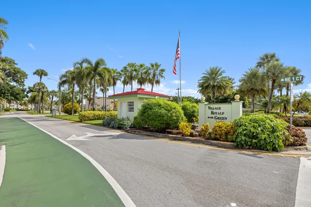 a front view of a house with a garden and a yard