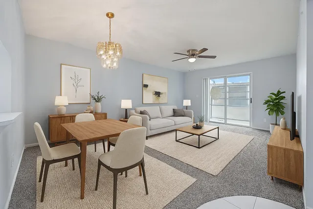 a living room with furniture a chandelier and a window