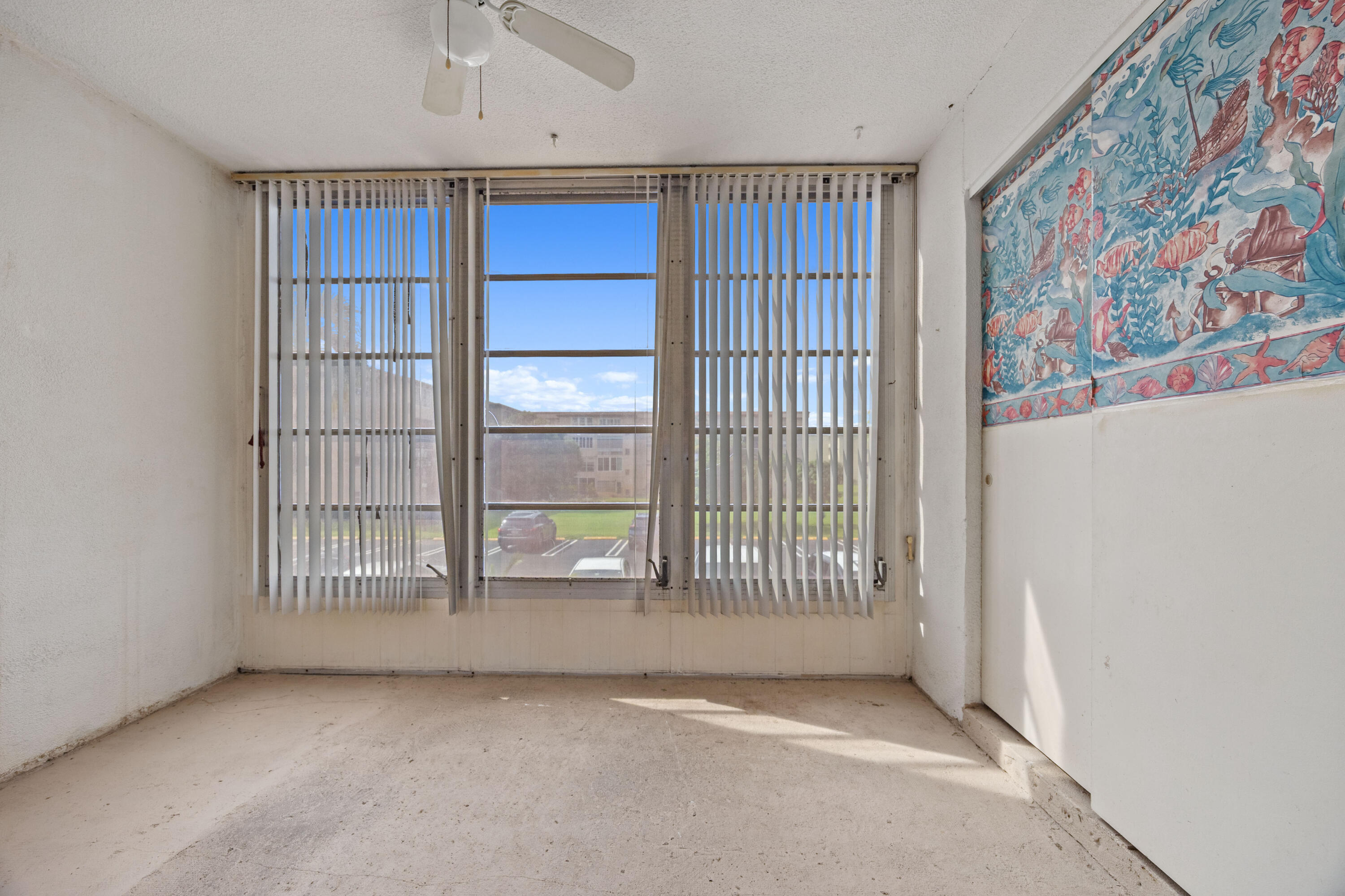 230 Northeast 26th Avenue, Unit 206 Boynton Beach, FL 33435 - Photo 5 of 25 a view of an empty room with a window