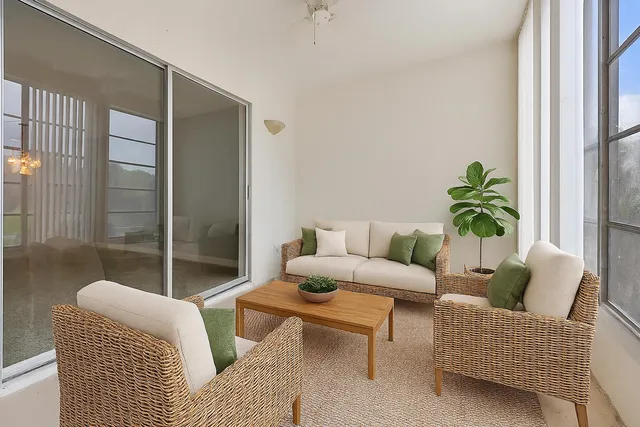a living room with furniture and a potted plant