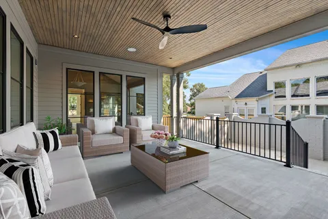 a living room with furniture and large windows