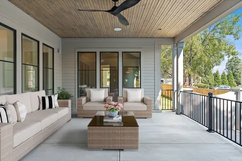 a view of a porch with furniture and a potted plant