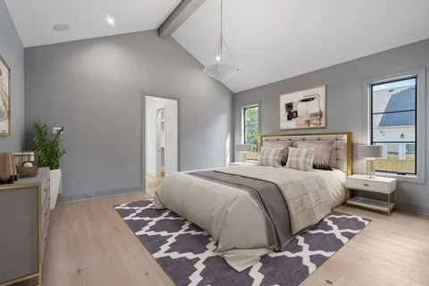 a spacious bedroom with a bed and a dresser