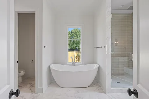 a bathroom with a tub shower and sink