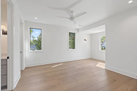 a bathroom with a sink a toilet a mirror a bathtub and shower