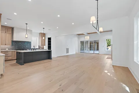 a kitchen with stainless steel appliances granite countertop a sink a stove and a refrigerator