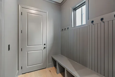 a view of an empty room with a kitchen and window