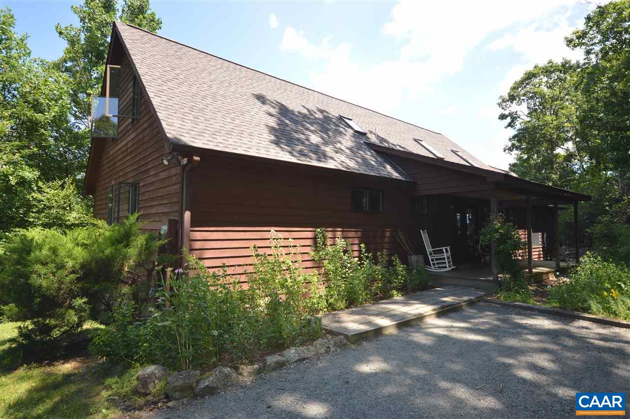 461 Tower Road Stanardsville, VA 22973 - Photo 1 of 1 a backyard of a house with yard and outdoor seating