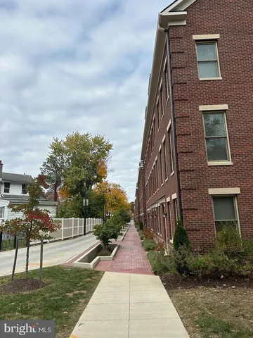 a pathway of a house with a yard