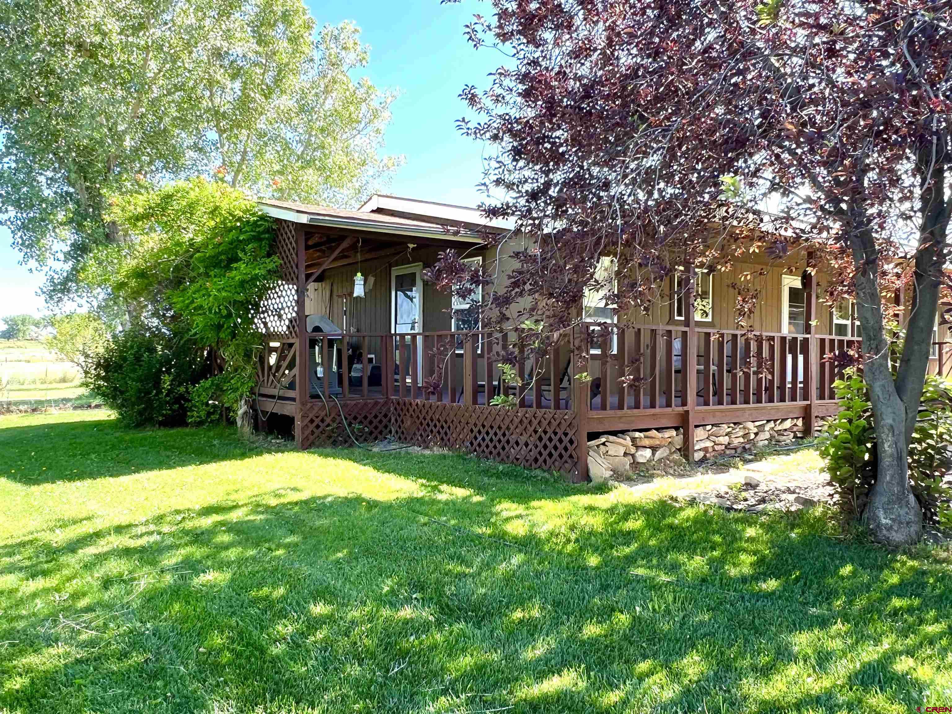 21179 Rd C.6 Cortez, CO 81321 - Photo 1 of 33 a view of a chair and table in backyard of the house