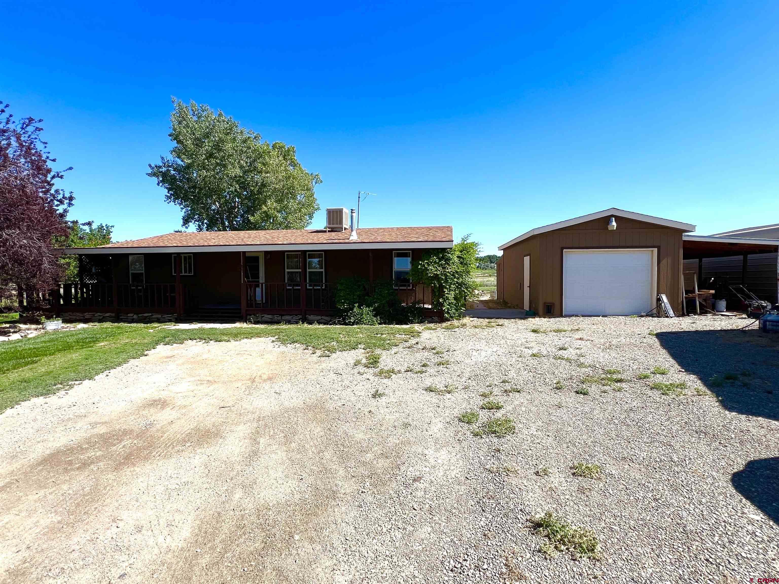 21179 Rd C.6 Cortez, CO 81321 - Photo 2 of 33 a front view of house with yard and trees in the background