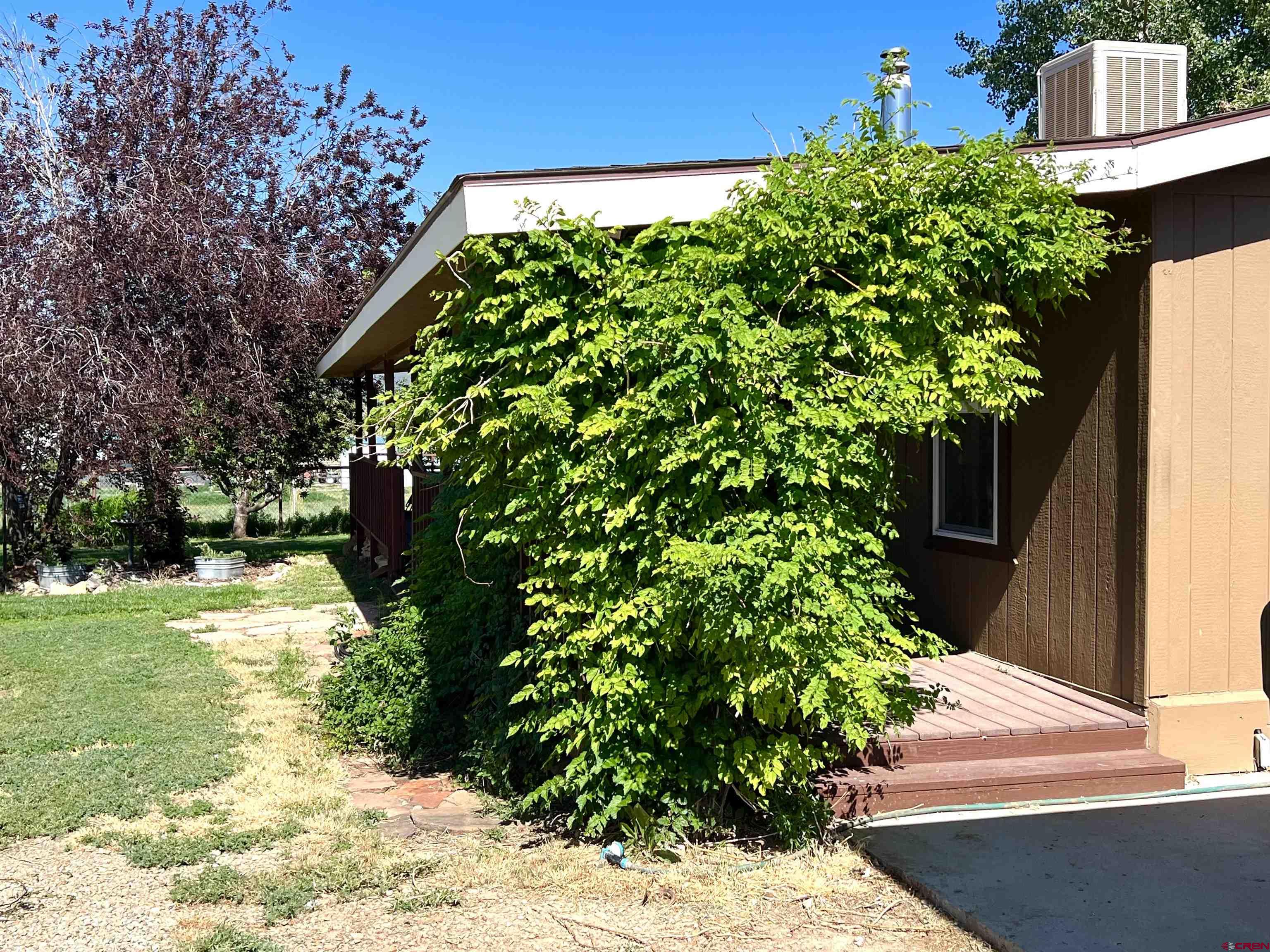 21179 Rd C.6 Cortez, CO 81321 - Photo 23 of 33 a backyard of a house with a yard and outdoor seating
