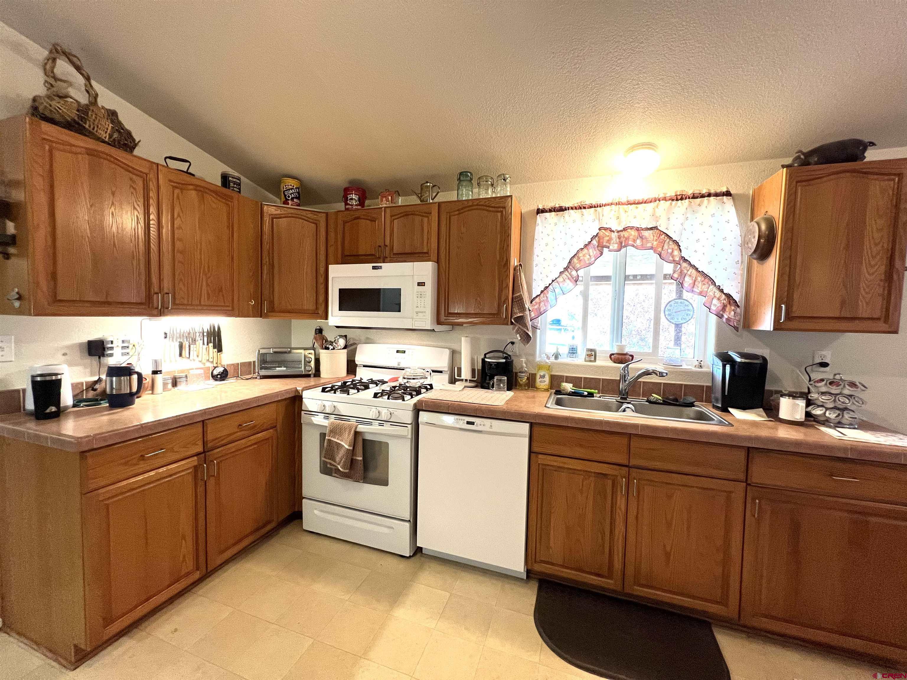 21179 Rd C.6 Cortez, CO 81321 - Photo 7 of 33 a kitchen with a sink cabinets and appliances