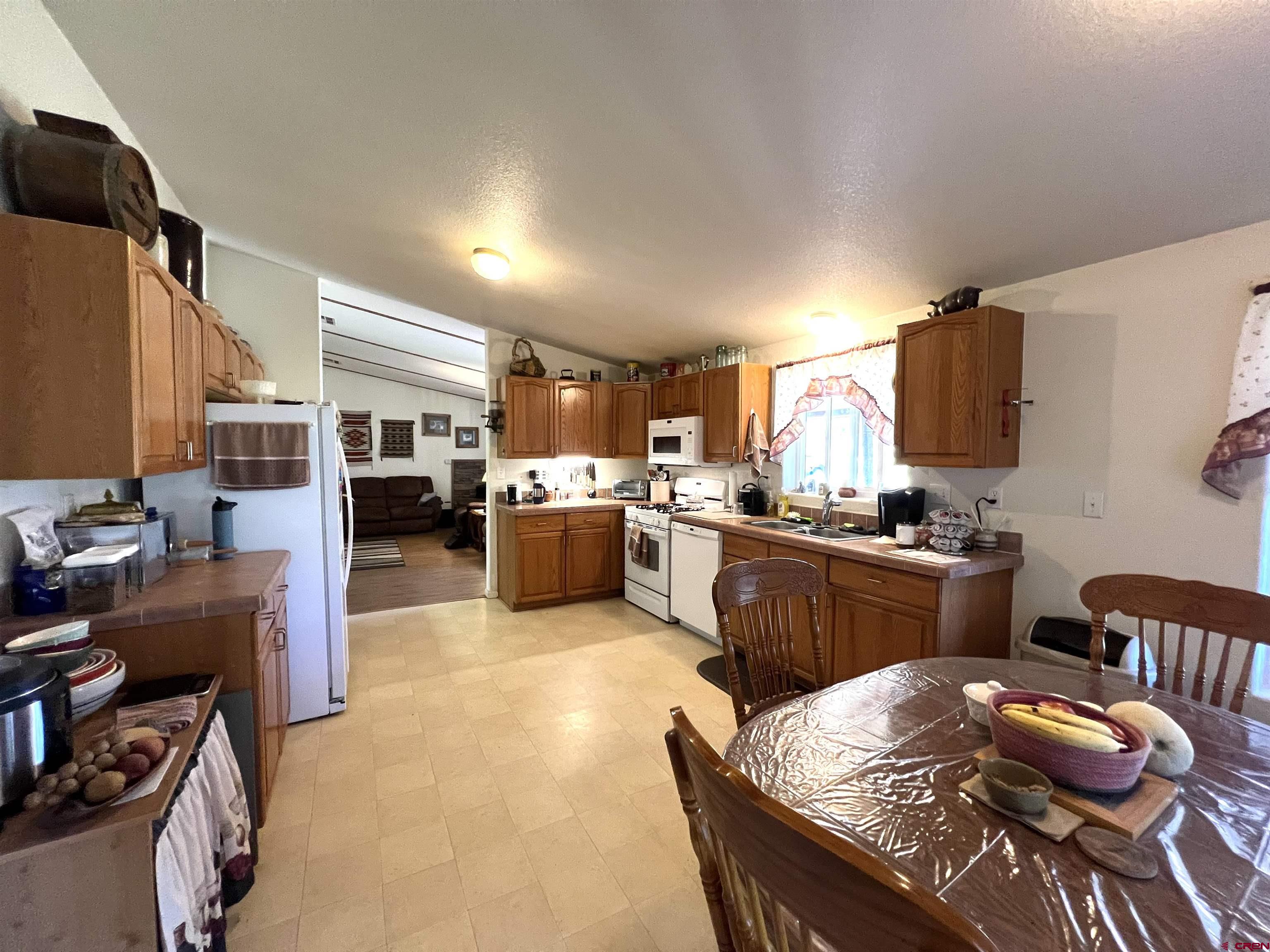 21179 Rd C.6 Cortez, CO 81321 - Photo 8 of 33 a kitchen with stainless steel appliances kitchen island granite countertop a stove and a refrigerator