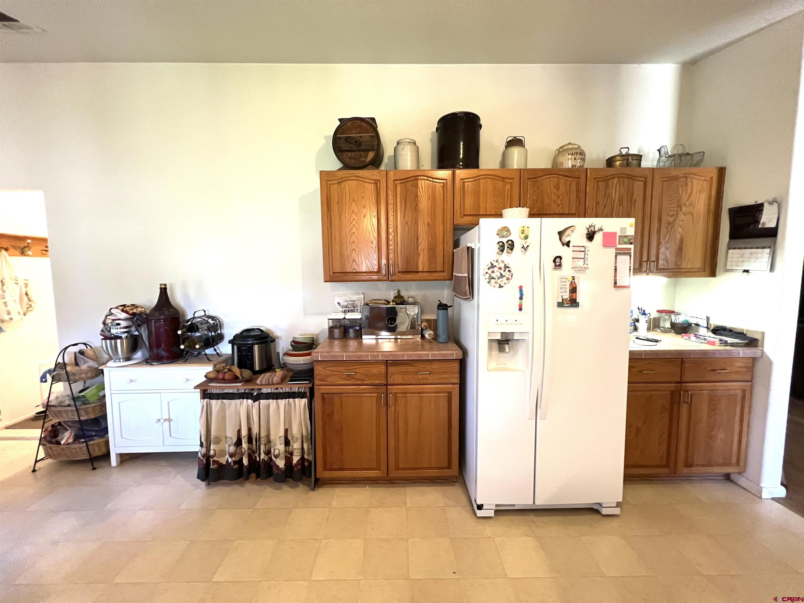 21179 Rd C.6 Cortez, CO 81321 - Photo 9 of 33 a kitchen with refrigerator and cabinets