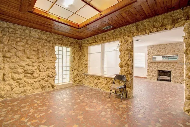 a living room with a couch next to a fireplace