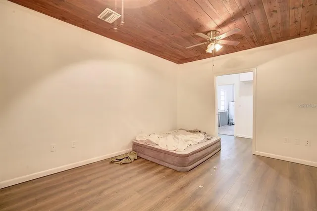 a view of a room with wooden floor and white walls