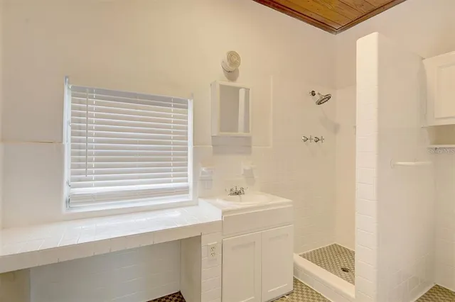 a bathroom with a sink a toilet and a window