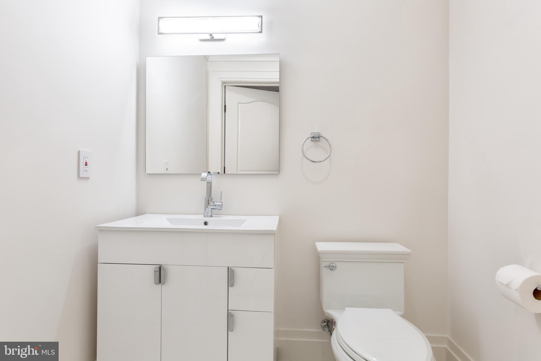 1181 Ballantrae Lane McLean, VA 22101 - Photo 67 of 85 a bathroom with a toilet sink and mirror