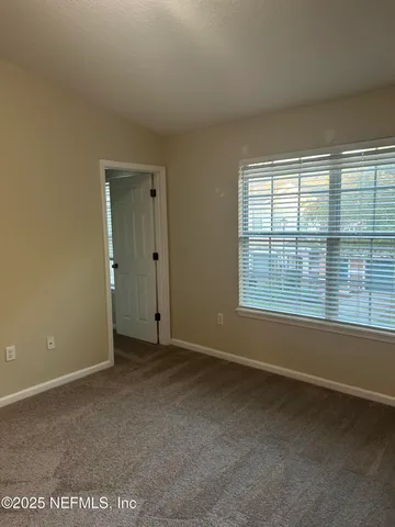 an empty room with a bathroom and a sink