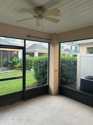 a view of a room with large windows and wooden floor