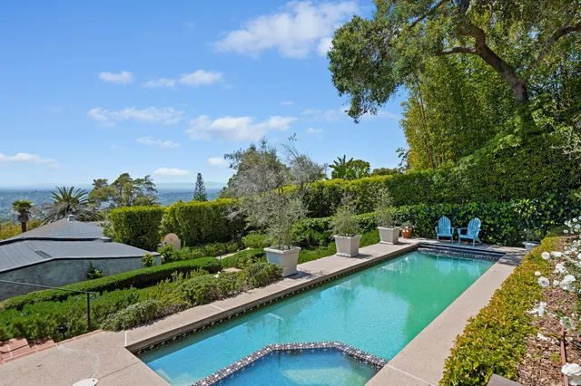 a view of a swimming pool with a yard