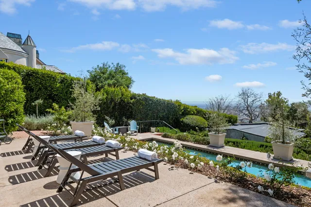 a view of a patio with table and chairs and potted plants