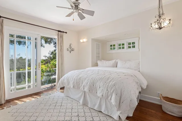a spacious bedroom with a bed and a window