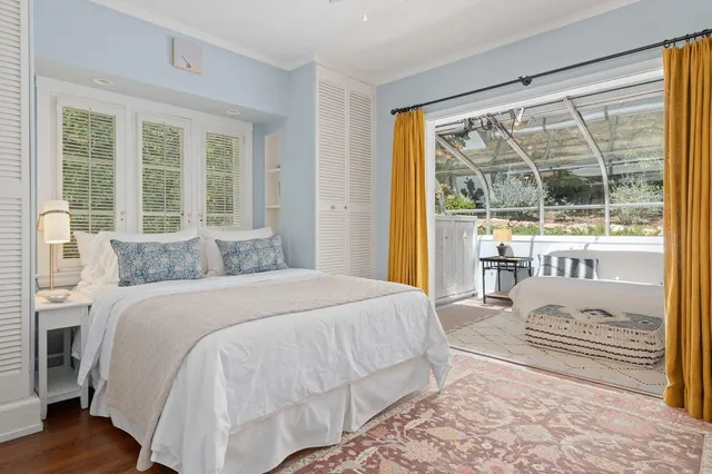 a bedroom with a large bed and a window