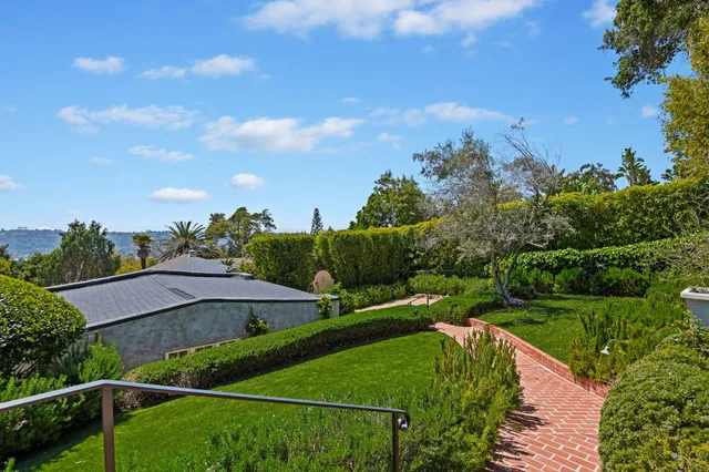 a view of a garden with a building in the background