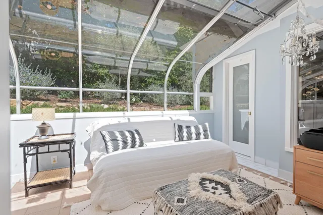 a bedroom with furniture and a large window