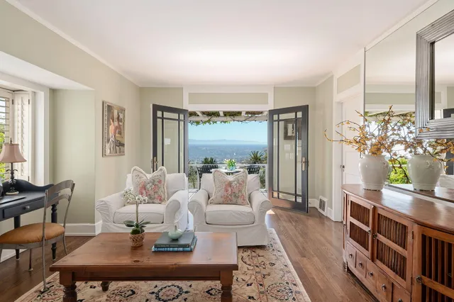 a living room with furniture fireplace and a large window