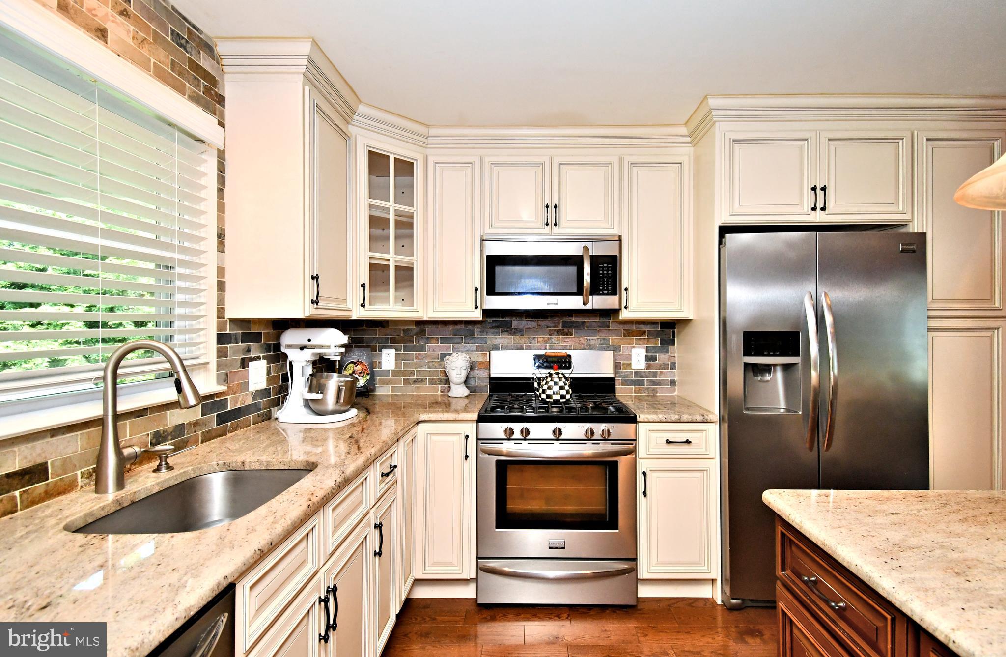 1014 Anna Road Huntingdon Valley, PA 19006 - Photo 14 of 54 a kitchen with stainless steel appliances a stove a sink a refrigerator and cabinets