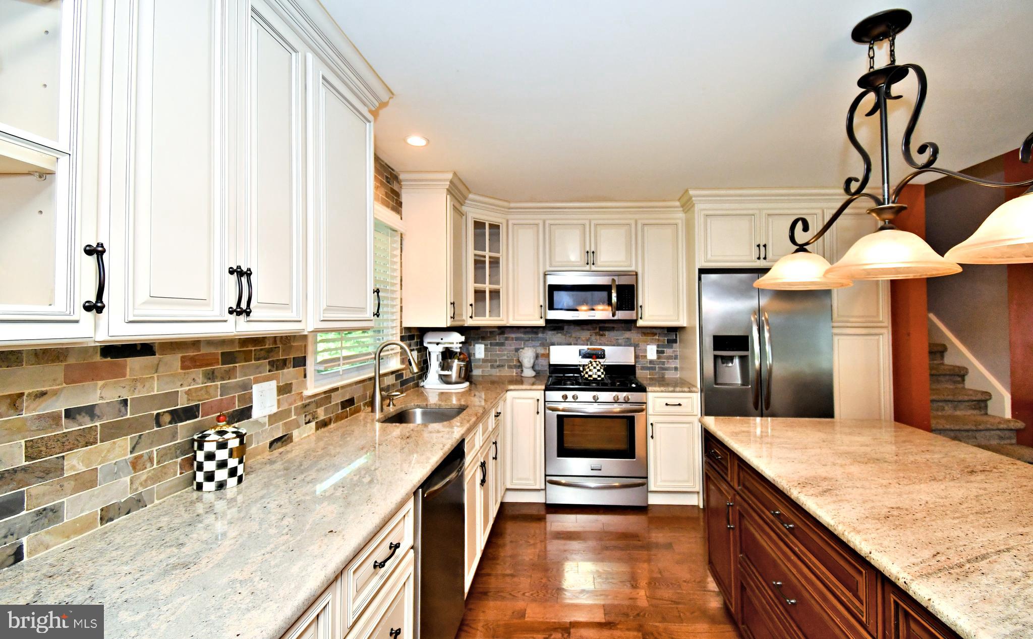 1014 Anna Road Huntingdon Valley, PA 19006 - Photo 16 of 54 a large kitchen with stainless steel appliances granite countertop a sink a stove and a wooden floors