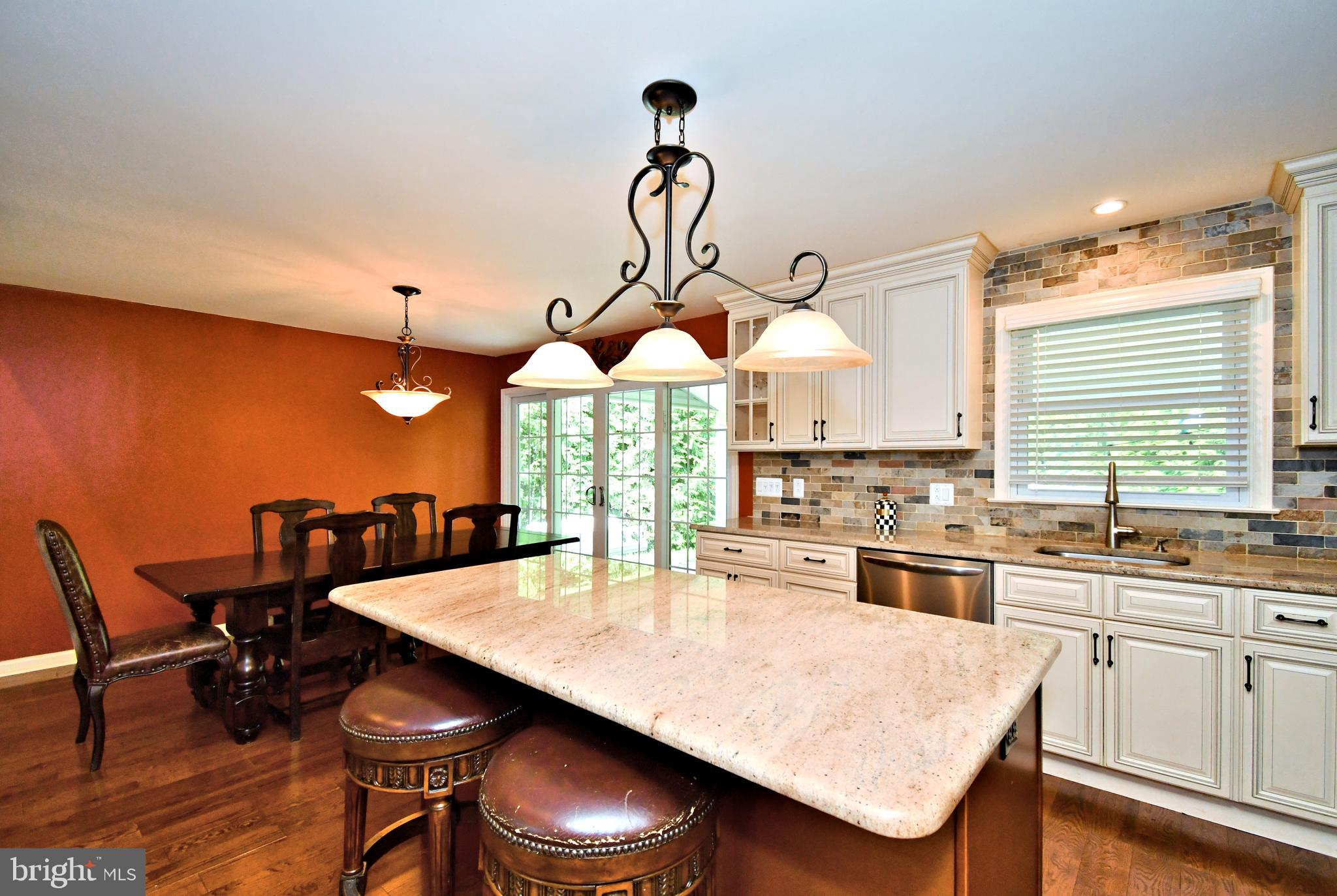 1014 Anna Road Huntingdon Valley, PA 19006 - Photo 20 of 54 a kitchen with stainless steel appliances granite countertop a dining table chairs and a refrigerator