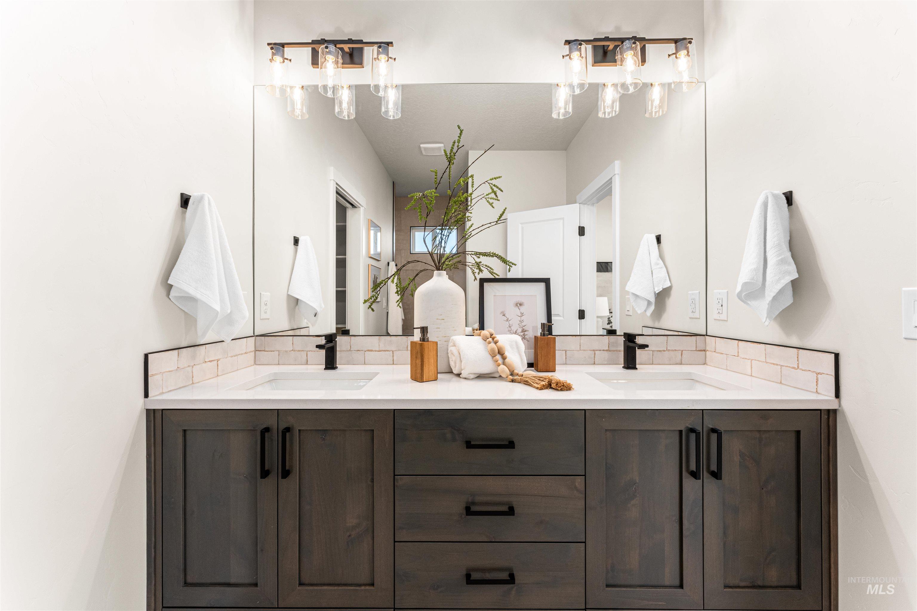 2787 West Warlander Street Meridian, ID 83642 - Photo 17 of 34 Bathroom featuring double vanity and tasteful backsplash