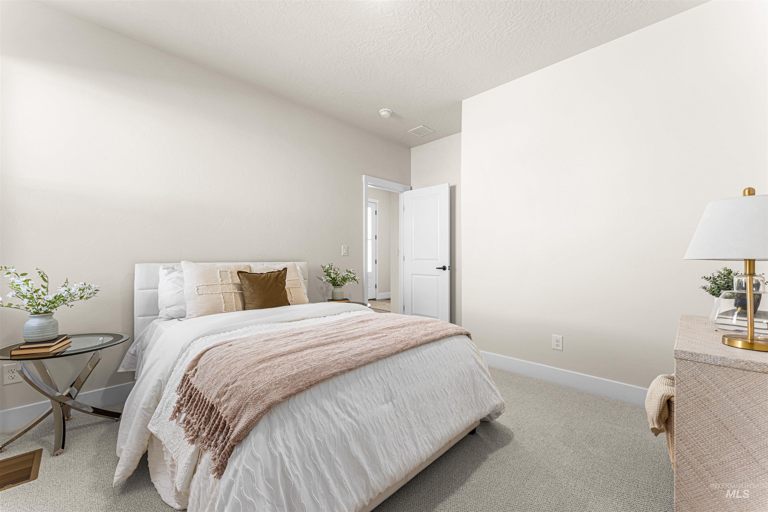 2787 West Warlander Street Meridian, ID 83642 - Photo 24 of 34 Bedroom with light carpet and a textured ceiling