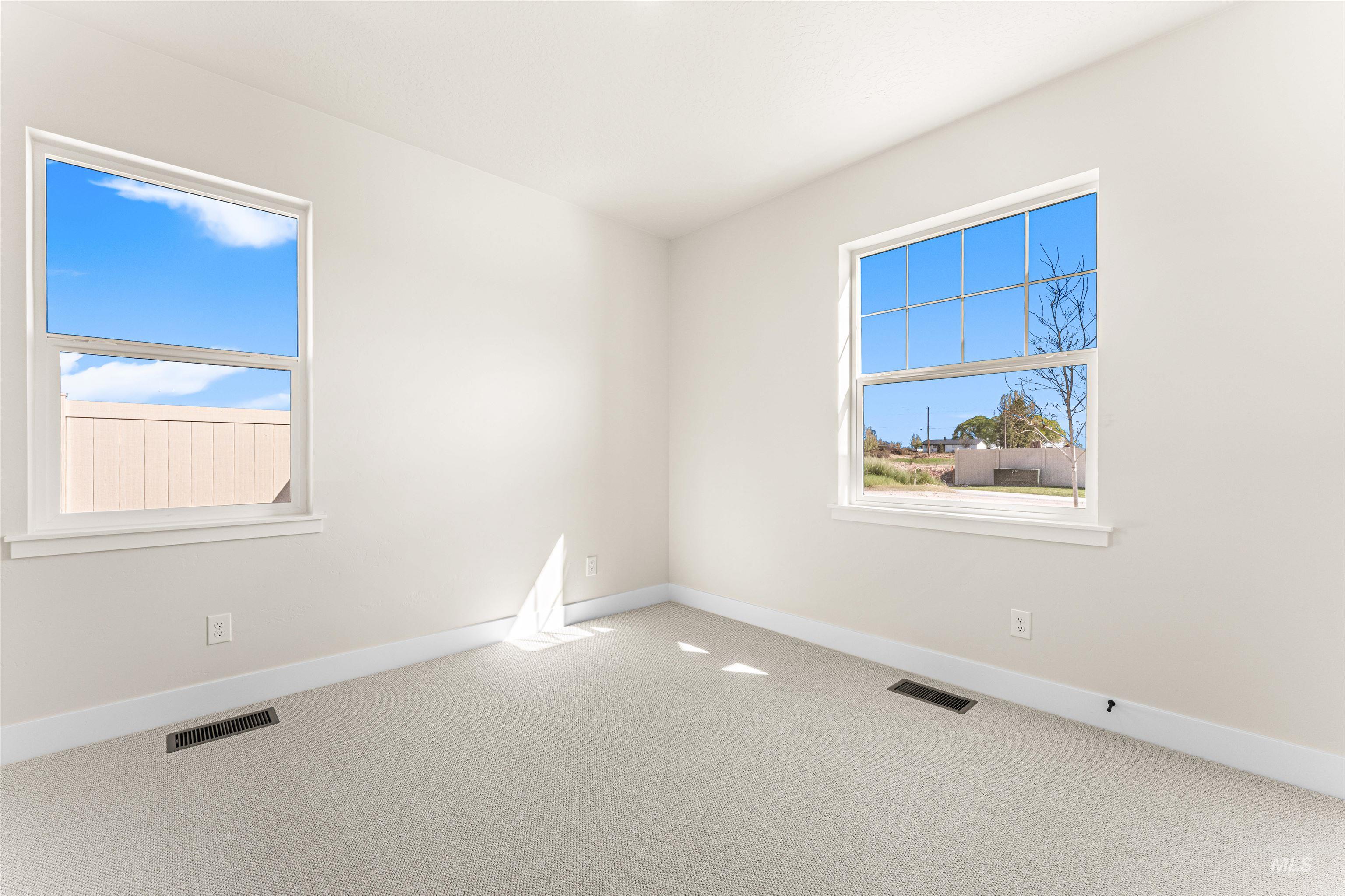 2787 West Warlander Street Meridian, ID 83642 - Photo 27 of 34 Unfurnished room featuring light colored carpet and plenty of natural light
