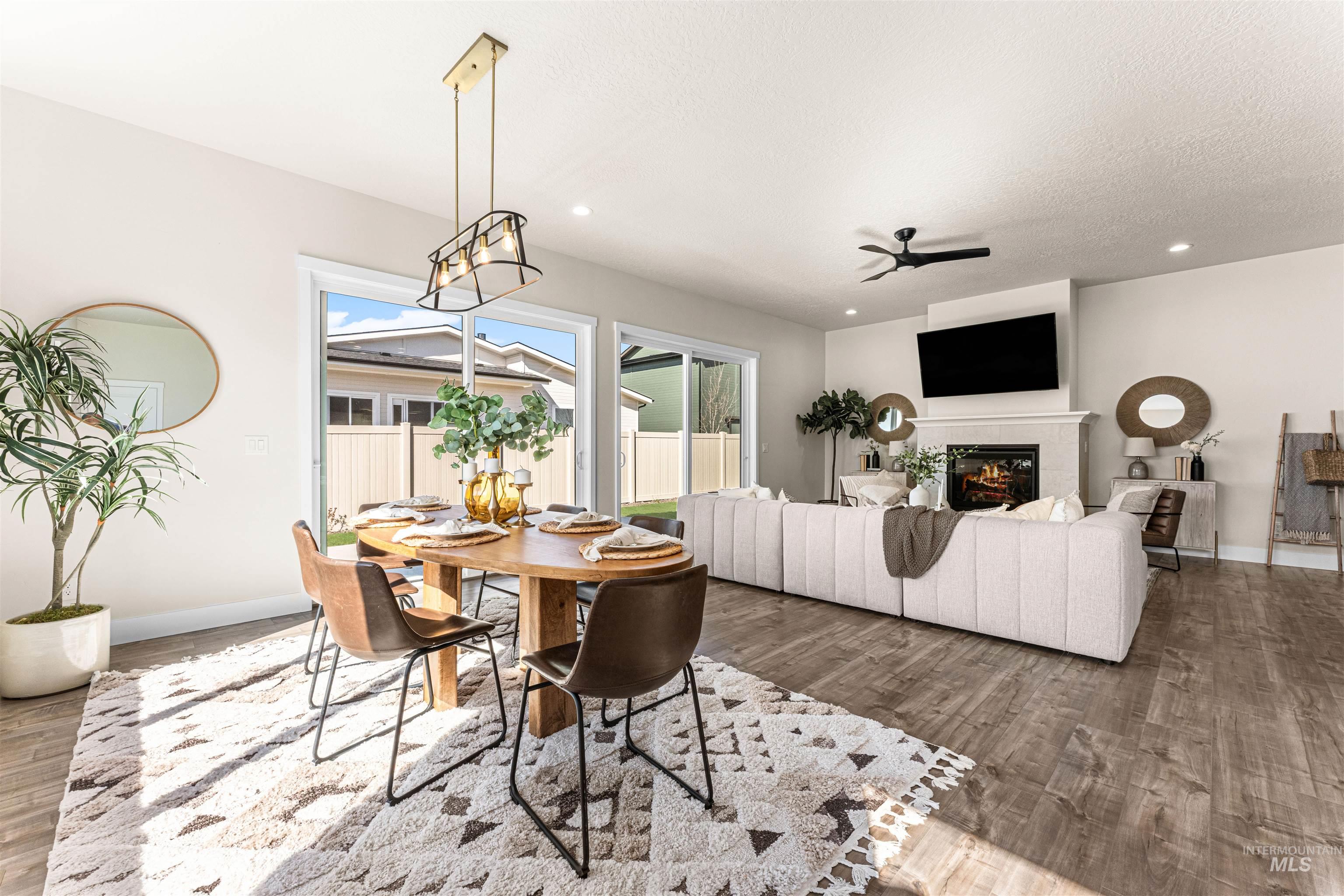 2787 West Warlander Street Meridian, ID 83642 - Photo 7 of 34 Dining space with wood finished floors, recessed lighting, ceiling fan, and a fireplace