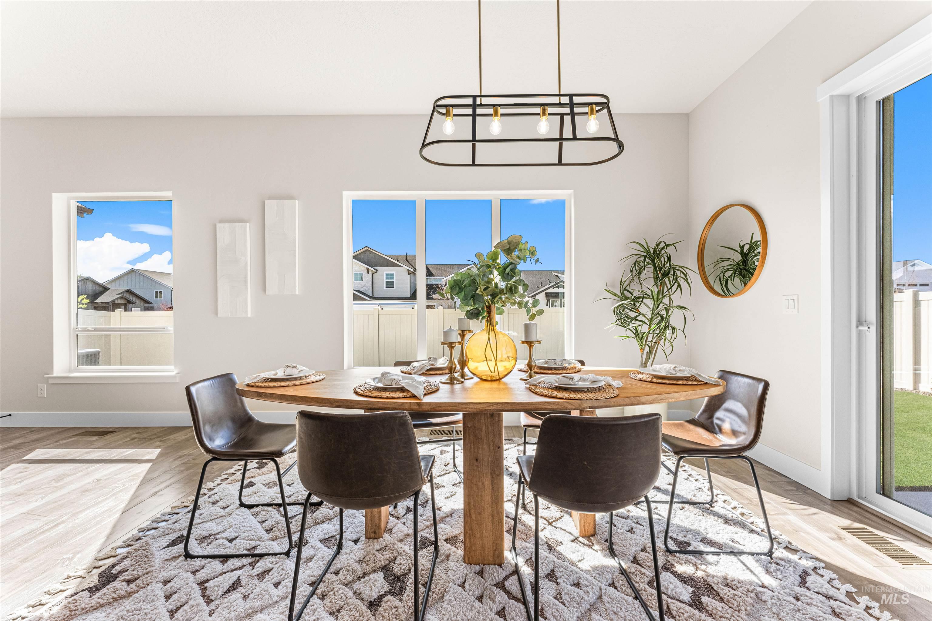 2787 West Warlander Street Meridian, ID 83642 - Photo 9 of 34 Dining space featuring light wood-style floors, healthy amount of natural light, and hanging lights