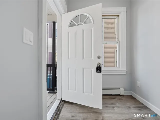 a view of front door with wooden floor
